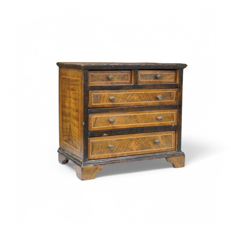 A miniature three long and two short inlaid chest of drawers, 21.5cm high x 23.5cm wide. Condition - poor to fair